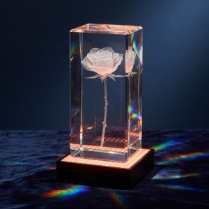 A tall crystal block with a long stemmed rose engraved inside