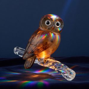 A small amber and smoke glass owl on a glass branch