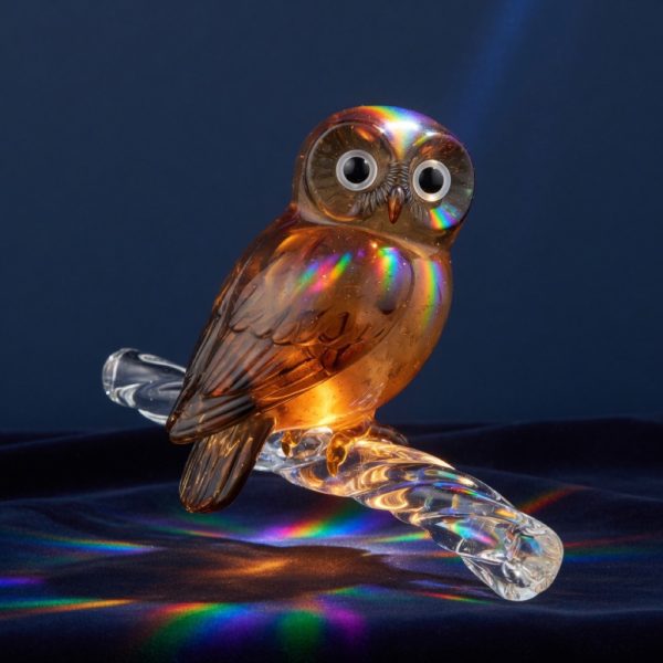 A small amber and smoke glass owl on a glass branch