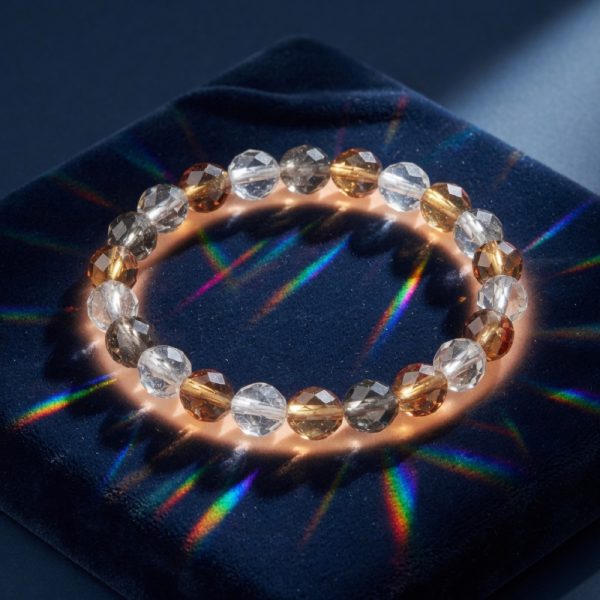 A stretch bracelet of clear, smoke and amber faceted glass beads